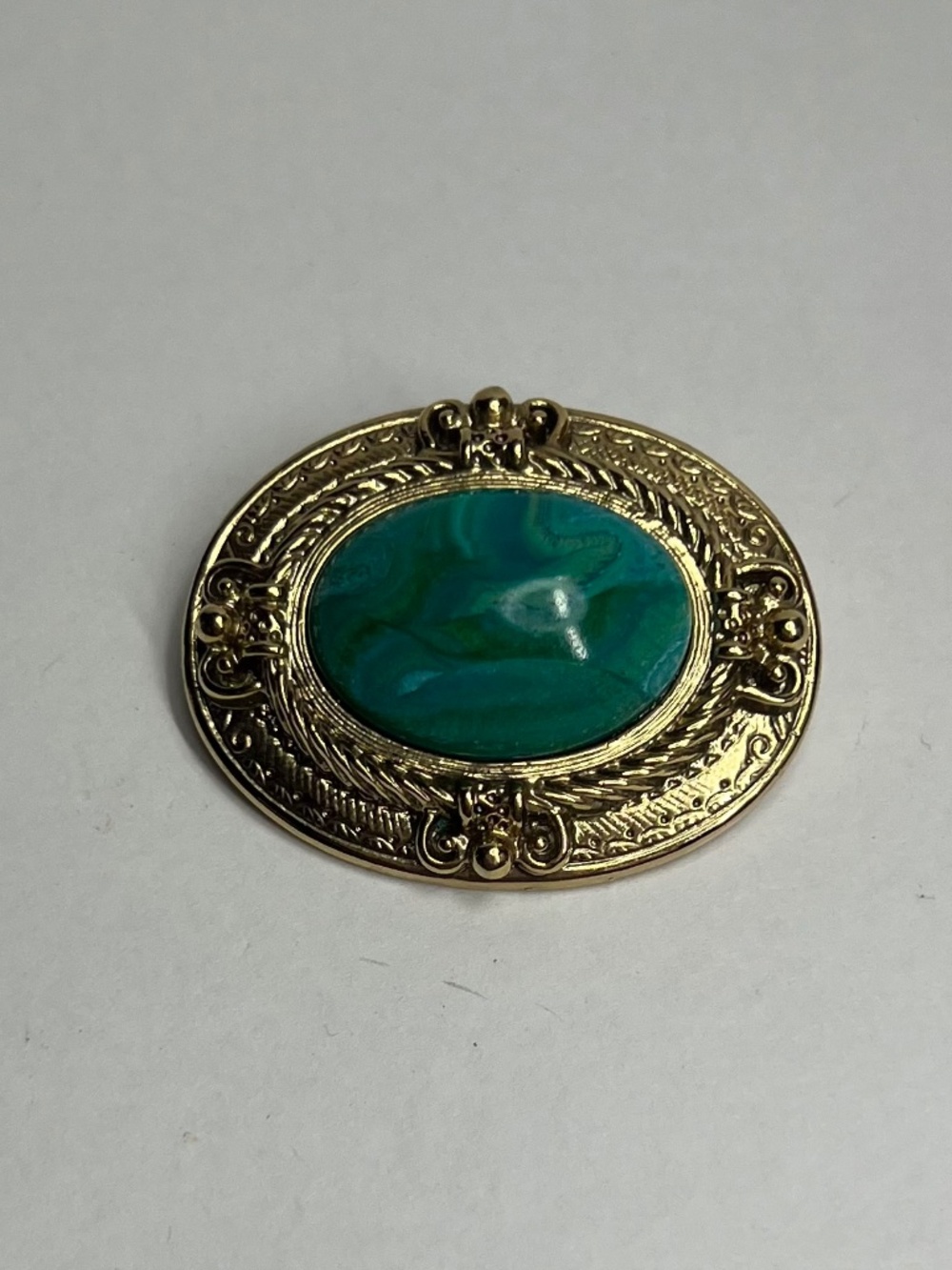 Green Malachite Brooch with ornate gold frame and swirling patterns #statement